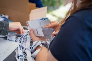 Ausgabe von Namensschildern und Lanyards am Empfang der Jubiläumsfeier